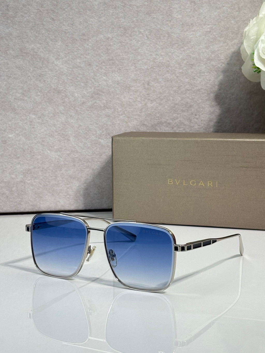 Bvlgari sunglasses with blue lenses and gold-tone square frames