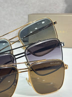 Gold-tone sunglasses close-up showing lens tints and BVLGARI logo on frames