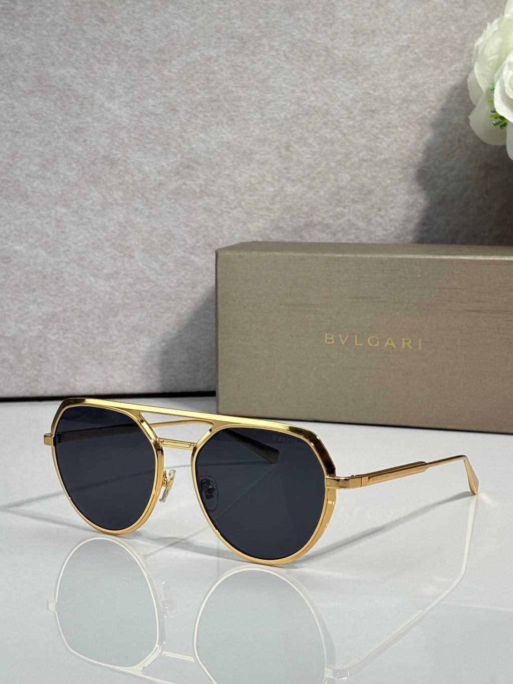 Bvlgari round sunglasses with dark lenses and gold metal frame