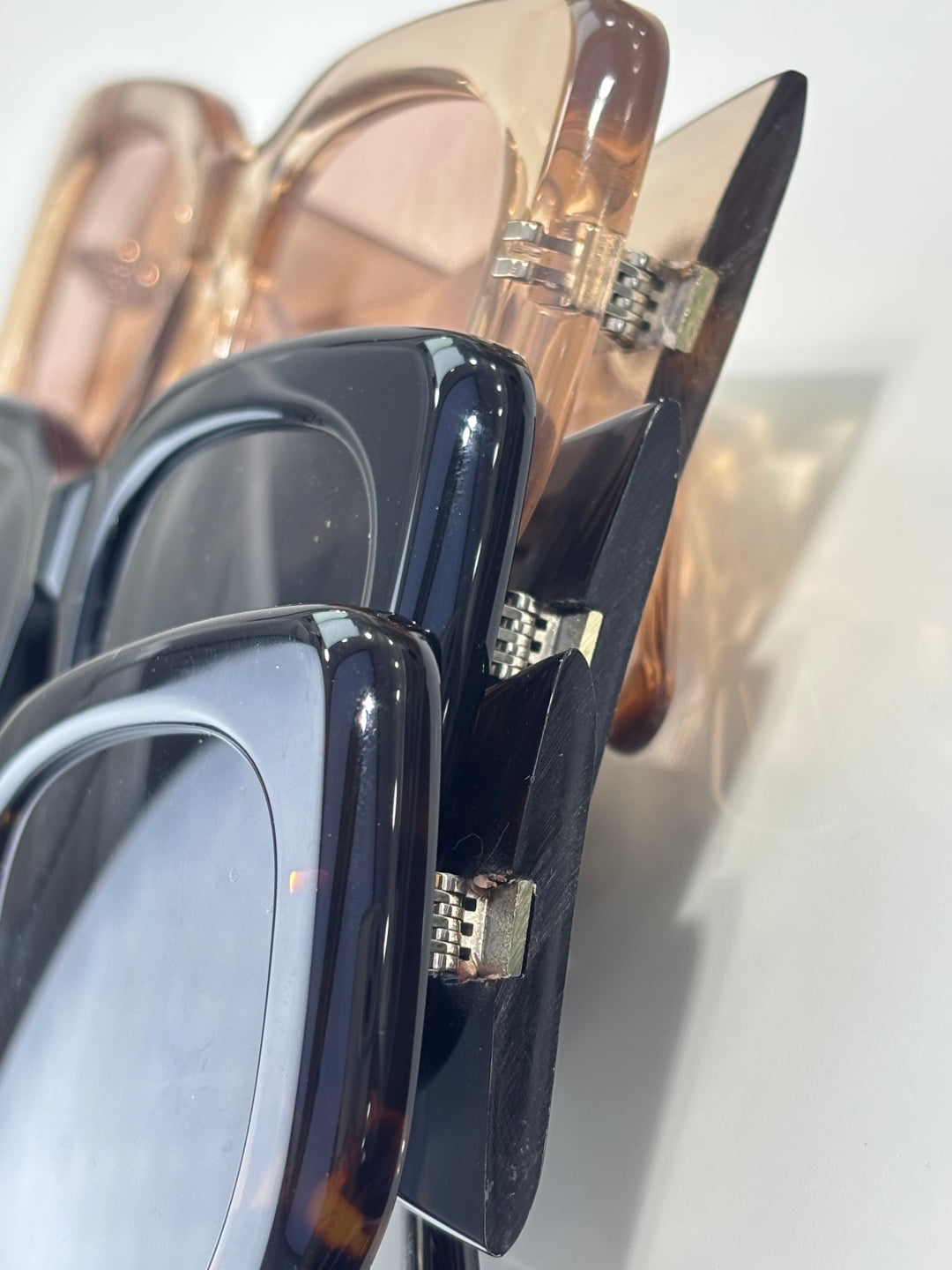 YSL sunglasses hinge detail with glossy dark frame and silver hardware