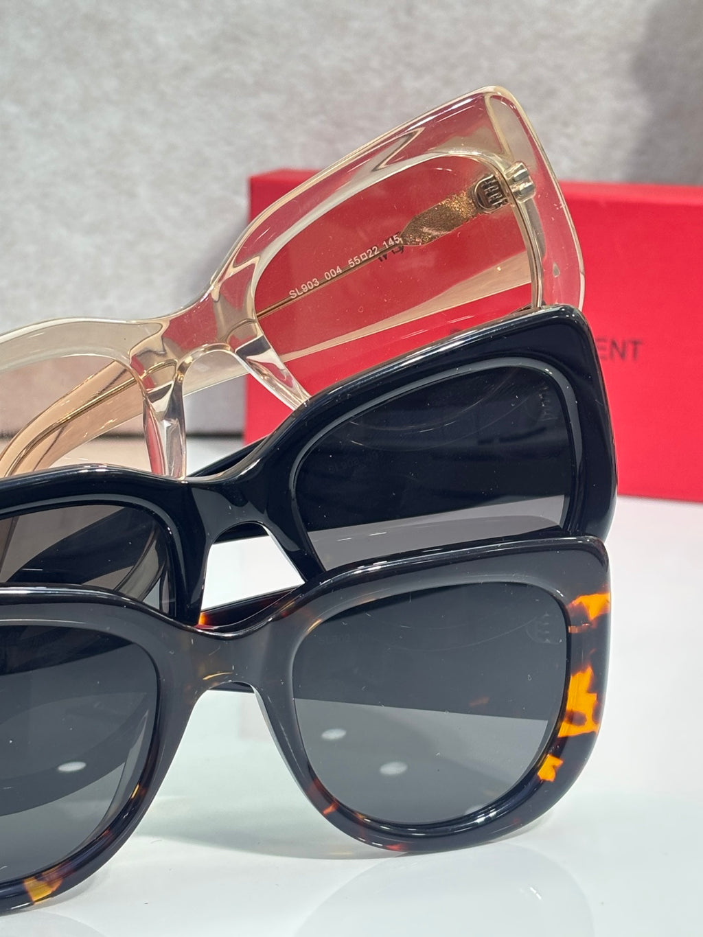 YSL sunglasses in case: black frames with dark lenses and rose frame with lenses