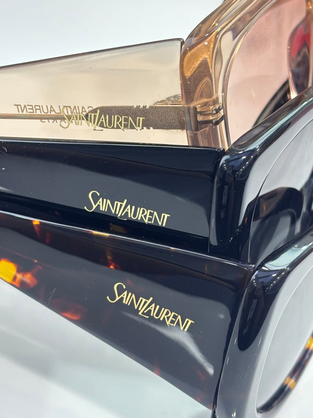 YSL glasses case with Saint Laurent logo on glossy blue exterior