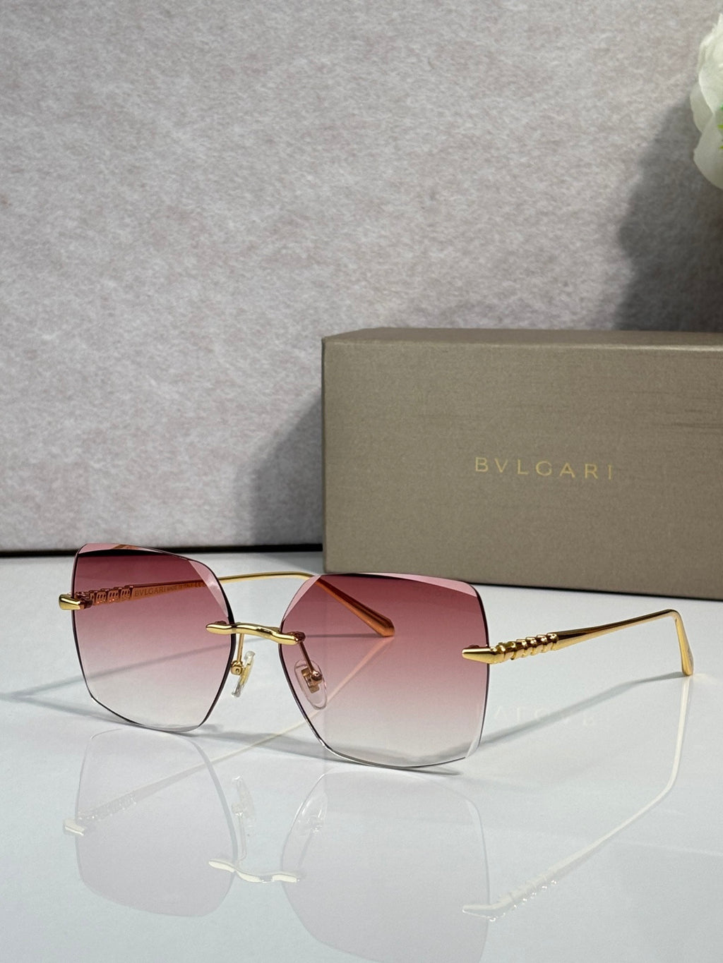 Gold-framed sunglasses with pink lenses and slim metal temples