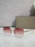 Gold-framed sunglasses with pink lenses and slim metal temples