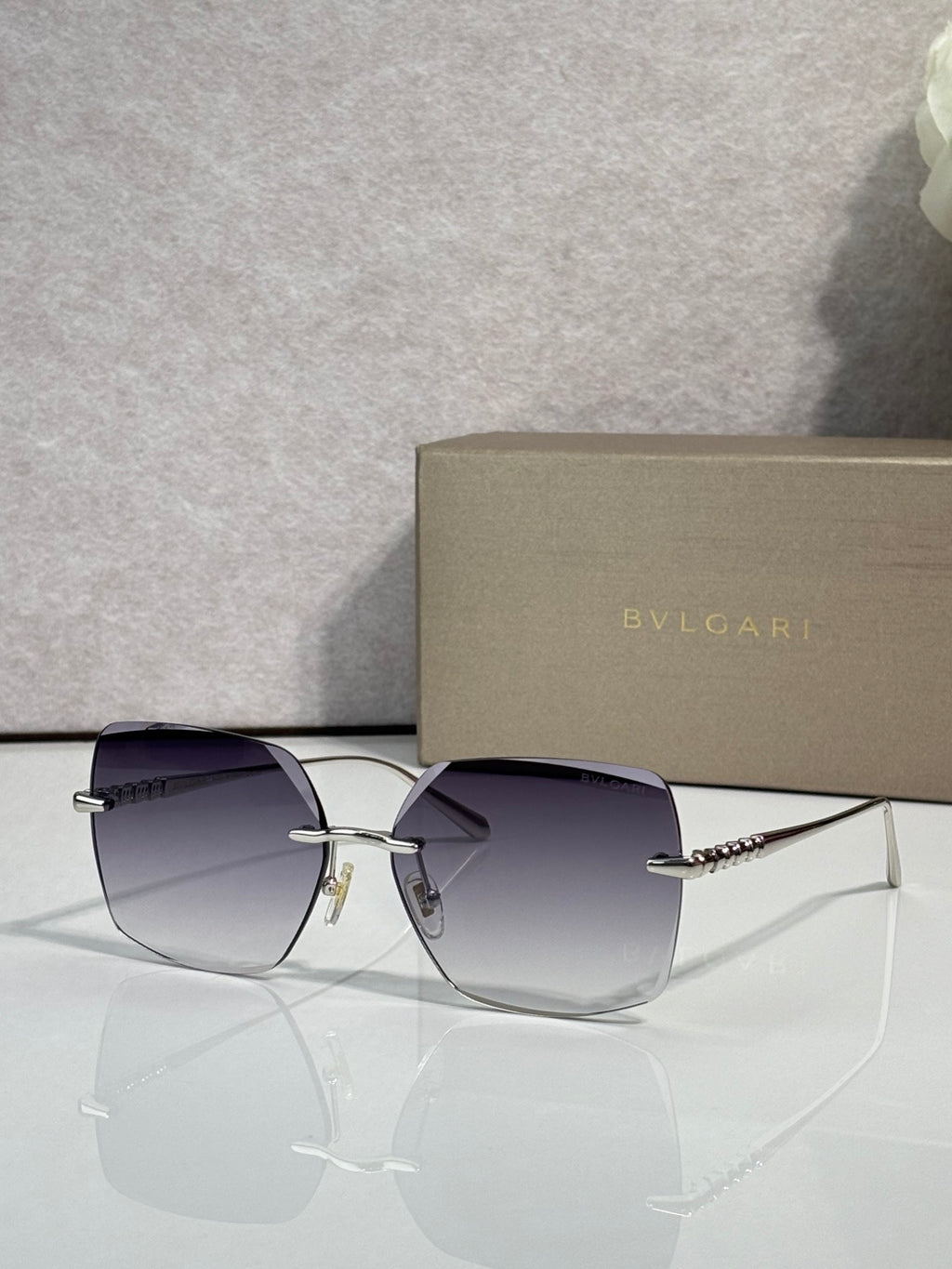 Gold-framed sunglasses with purple-tinted lenses and slim metal temples