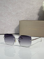 Gold-framed sunglasses with purple-tinted lenses and slim metal temples