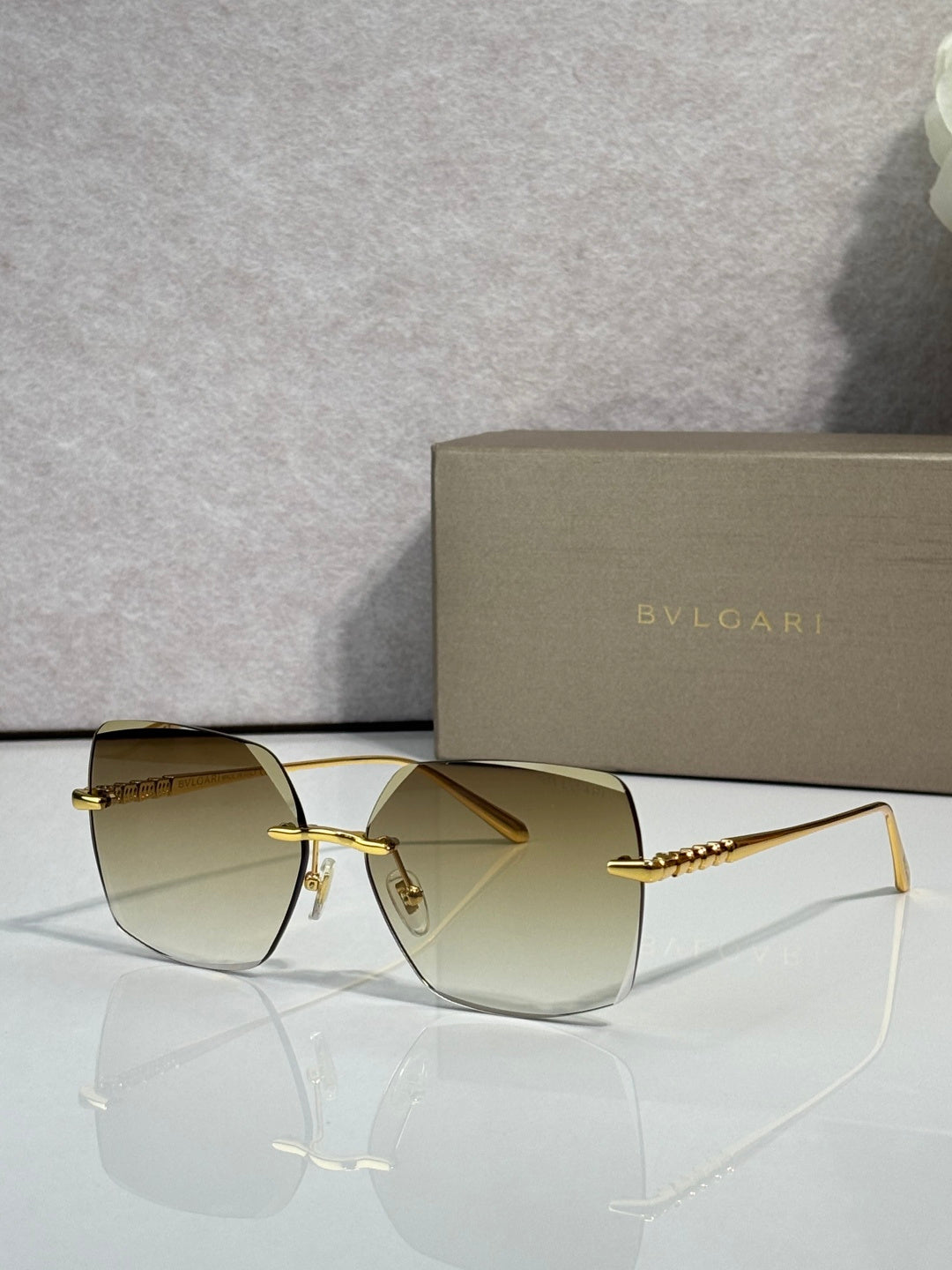 Gold-framed sunglasses with light olive lenses and slim metal temples