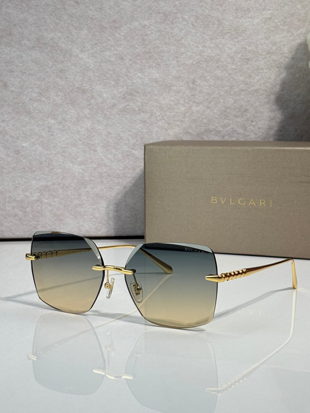 Gold-framed sunglasses with green-gold lenses and slim metal temples
