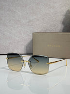Gold-framed sunglasses with green-gold lenses and slim metal temples
