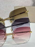 Gold sunglasses stacked view with tinted lenses and engraved top bar