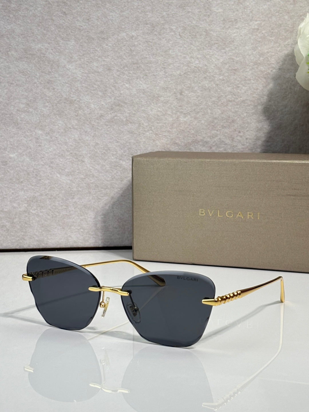 Bvlgari sunglasses, gold frame, deep blue lenses with curved bridge metal
