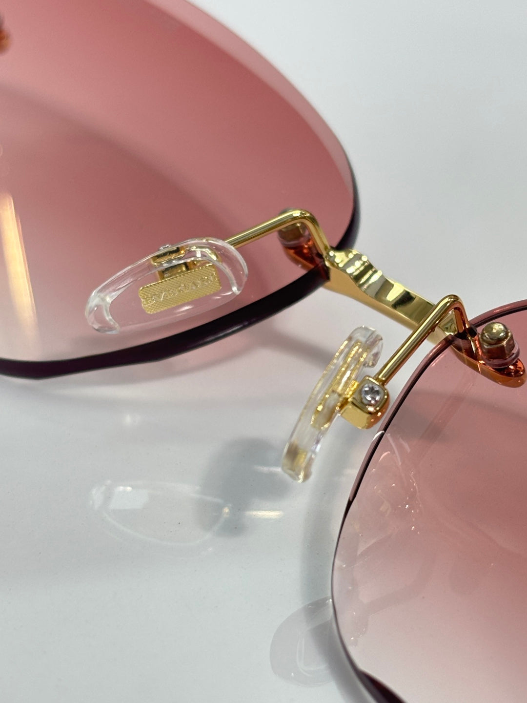 Bvlgari sunglasses close-up, gold hinge and temple with clear lens edge