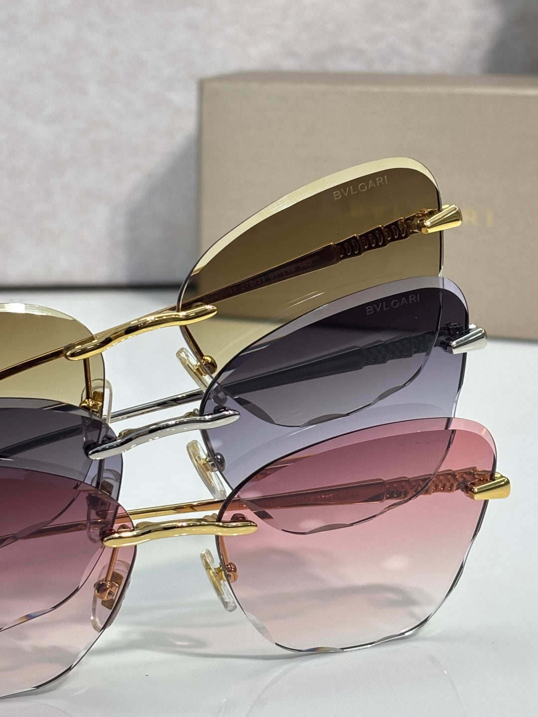 Bvlgari sunglasses gold frame, dark gradient lenses, curved temples with logo tip