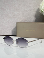 Bvlgari sunglasses with gold-tone frame and smoky blue lenses