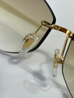 Bvlgari sunglasses close-up: gold hardware with black temple and lens rim