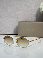 Bvlgari sunglasses with gold-tone frame and amber gradient lenses
