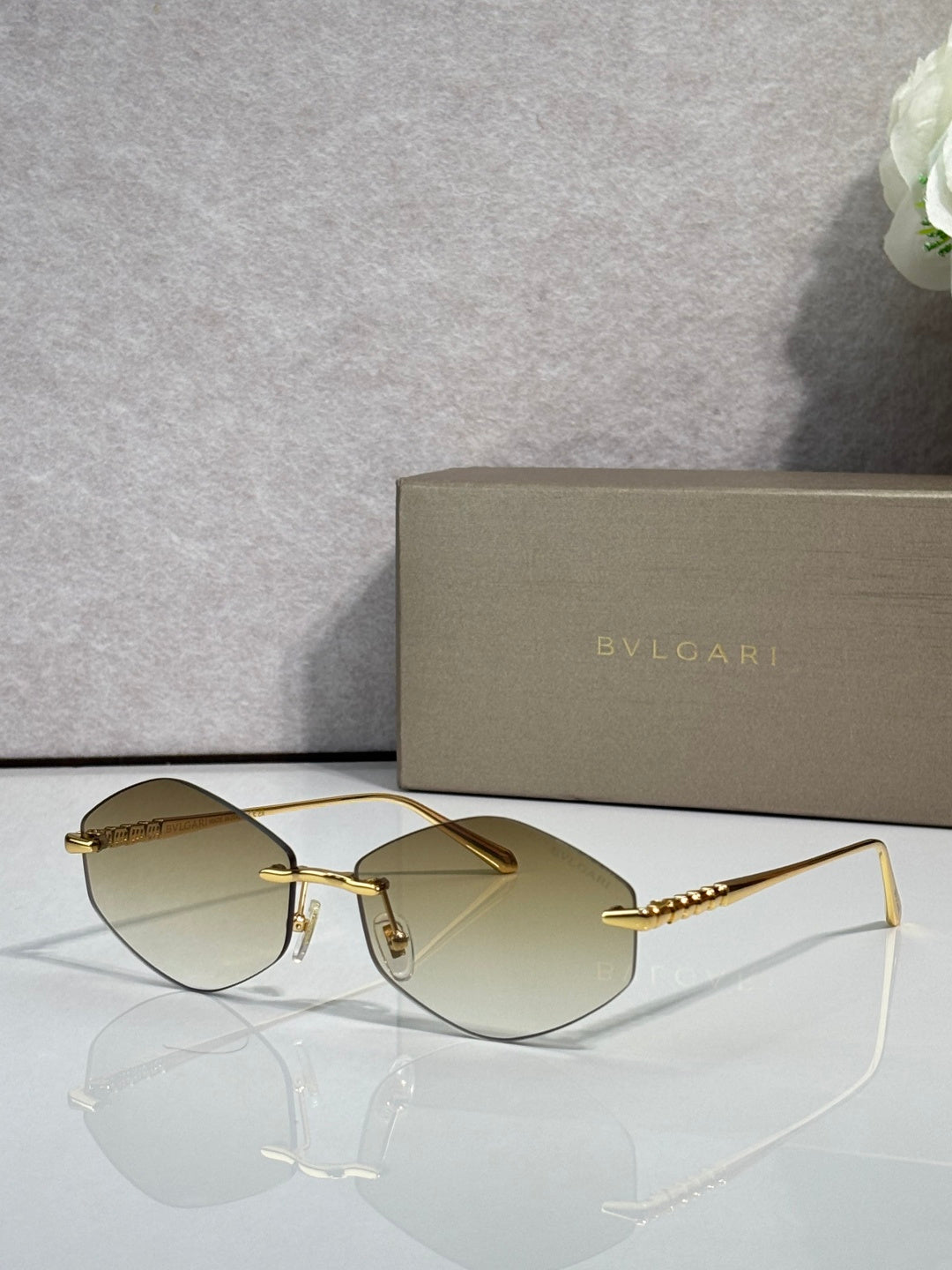 Bvlgari sunglasses with gold-tone frame and amber gradient lenses