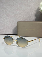 Bvlgari sunglasses with gold-tone frame and slate gray gradient lenses
