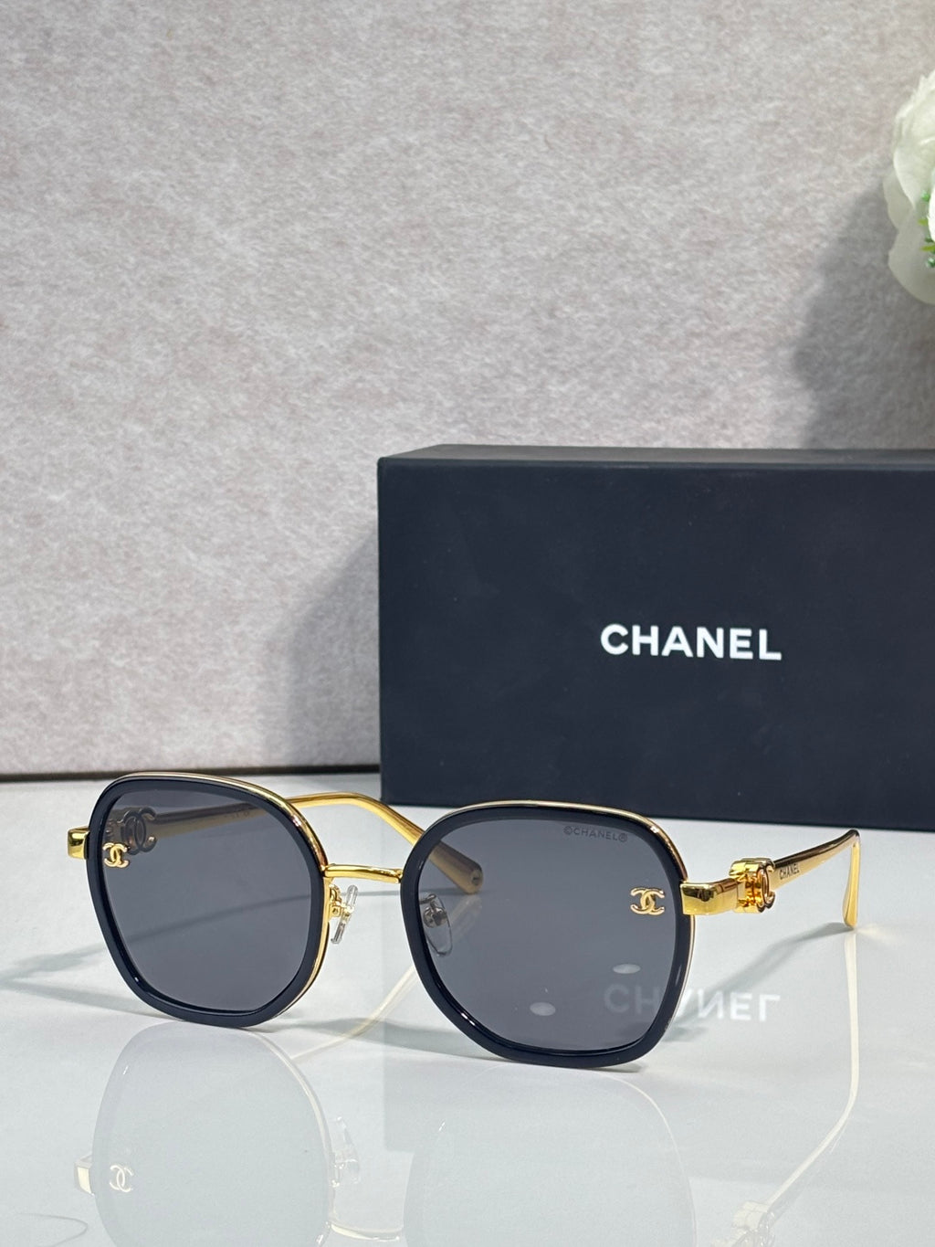 Chanel round sunglasses with dark lenses, gold-tone frame and navy details