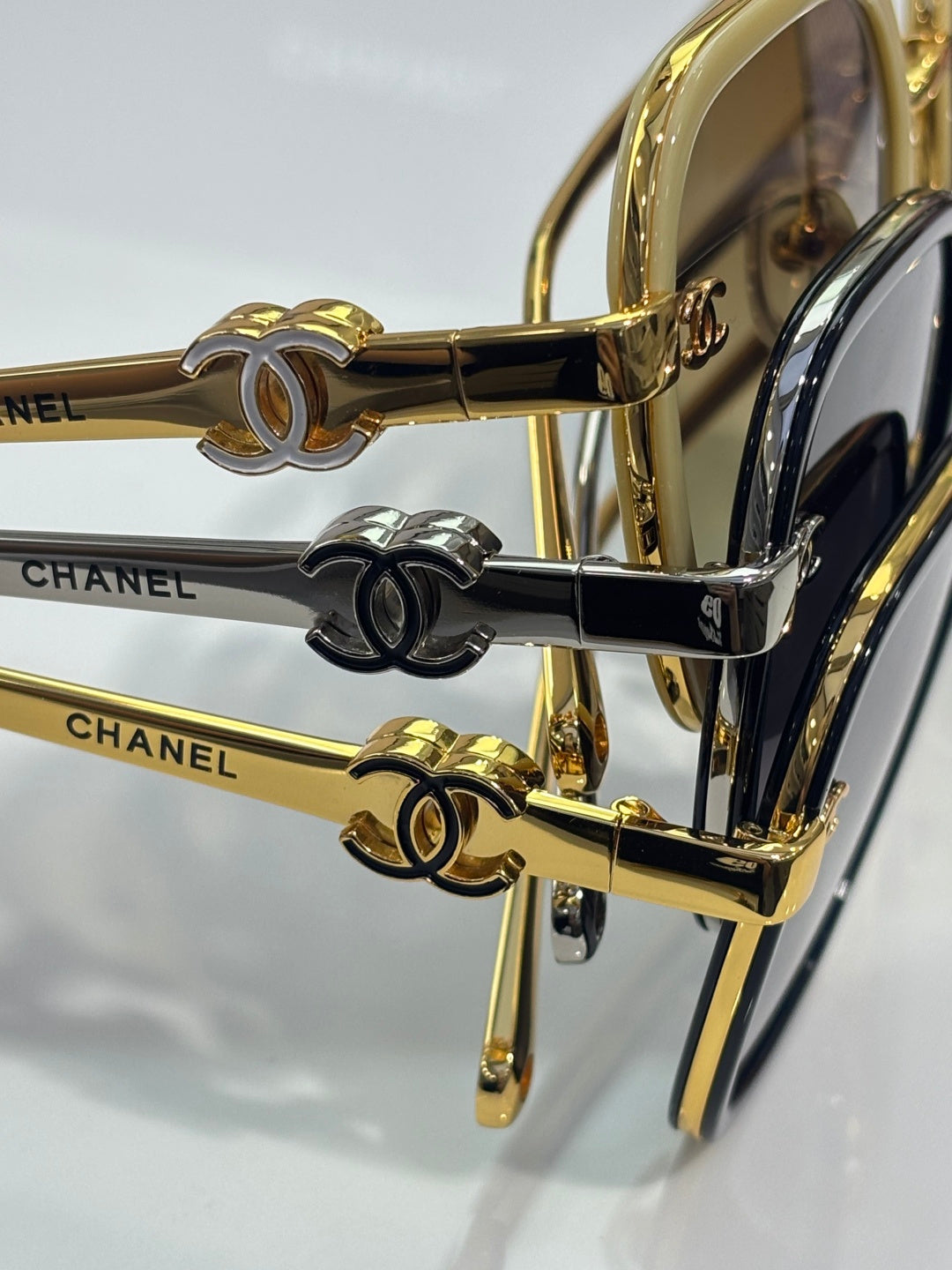Chanel sunglasses close-up of gold-tone temples with Double-C charms