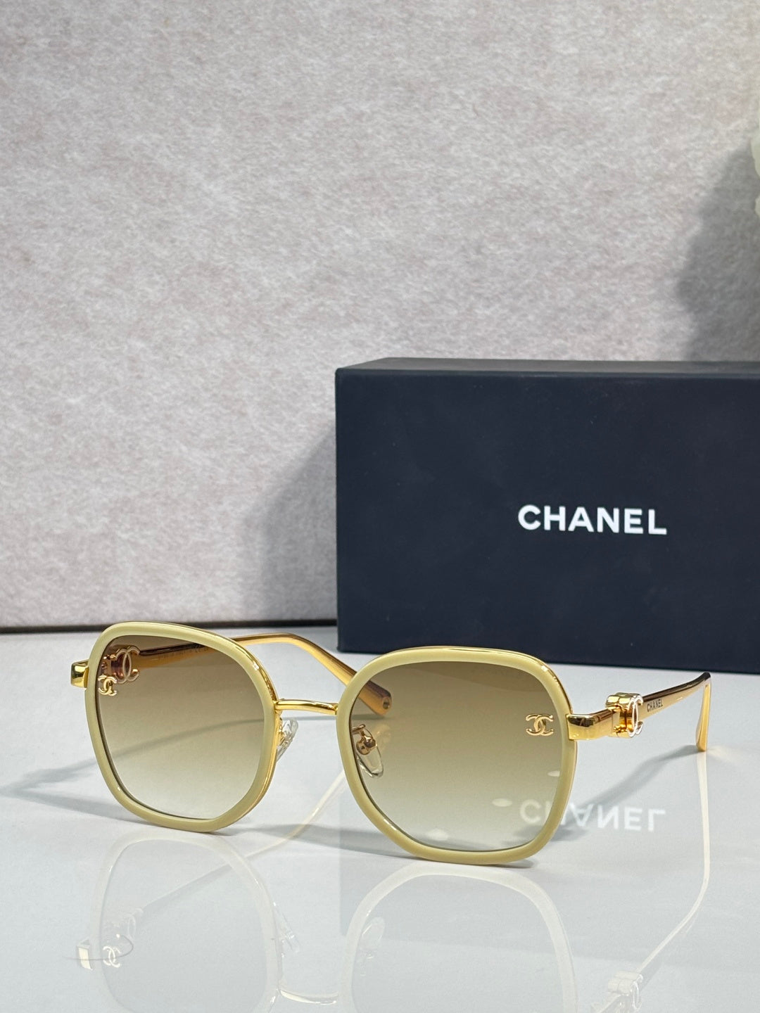 Chanel round sunglasses with cream-beige lenses and gold-tone metal frame