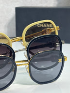 Chanel round sunglasses stacked; dark lens pair with gold-tone frame, other pairs partly visible