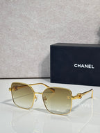 Gold-tone eyeglasses with rectangular rounded lenses and clear tinted finish