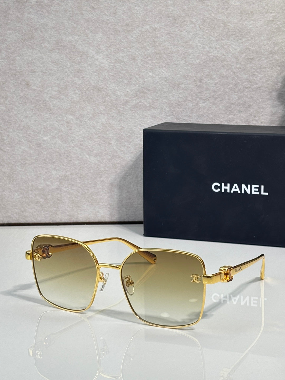 Gold-tone eyeglasses with rectangular rounded lenses and clear tinted finish
