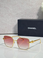Gold-tone eyeglasses with pink-tinted lenses and slim metal frame