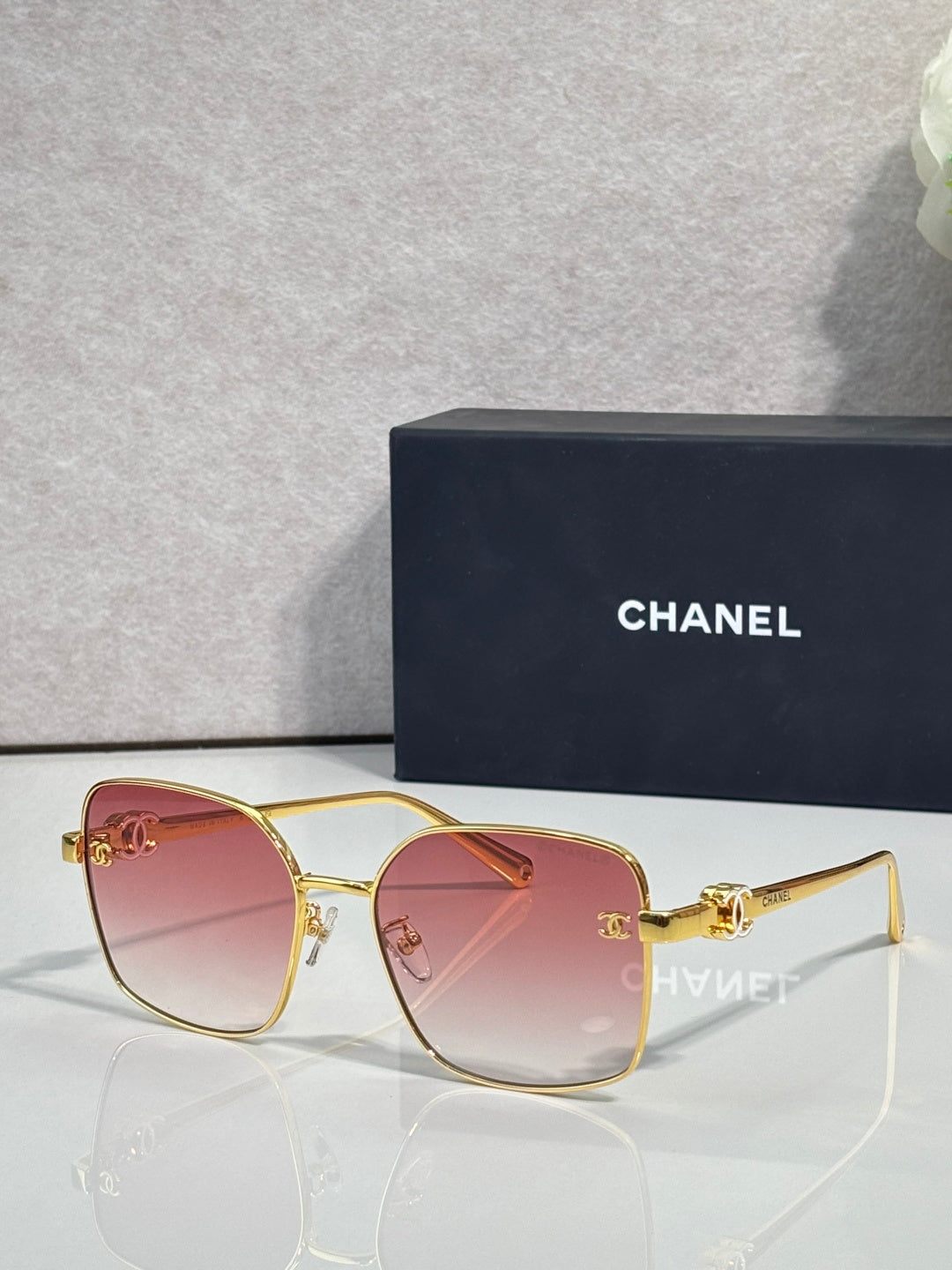 Gold-tone eyeglasses with pink-tinted lenses and slim metal frame
