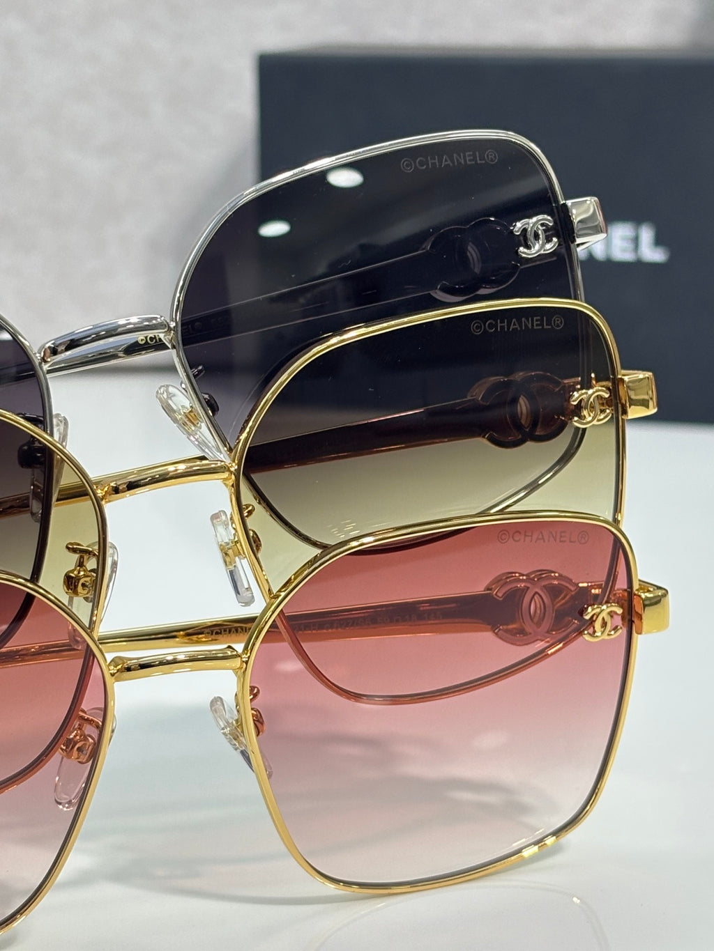 Gold-tone eyeglasses with pink-tinted lenses and dark inner frame detailing