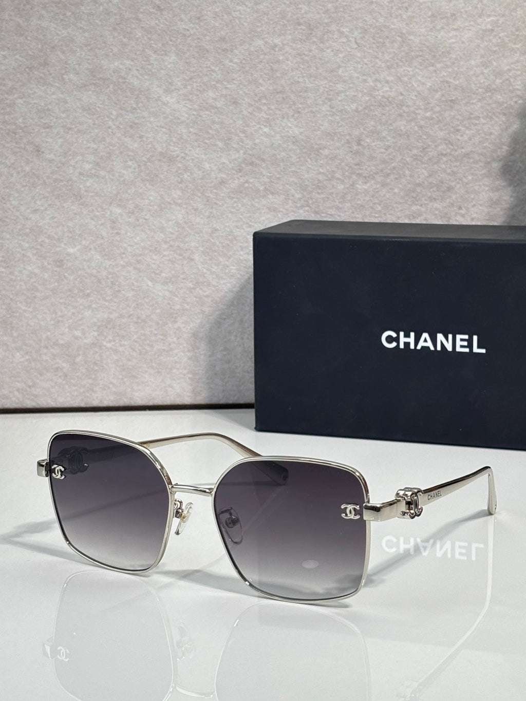 Silver-tone eyeglasses with dark lenses and thin metal frame with gold accents