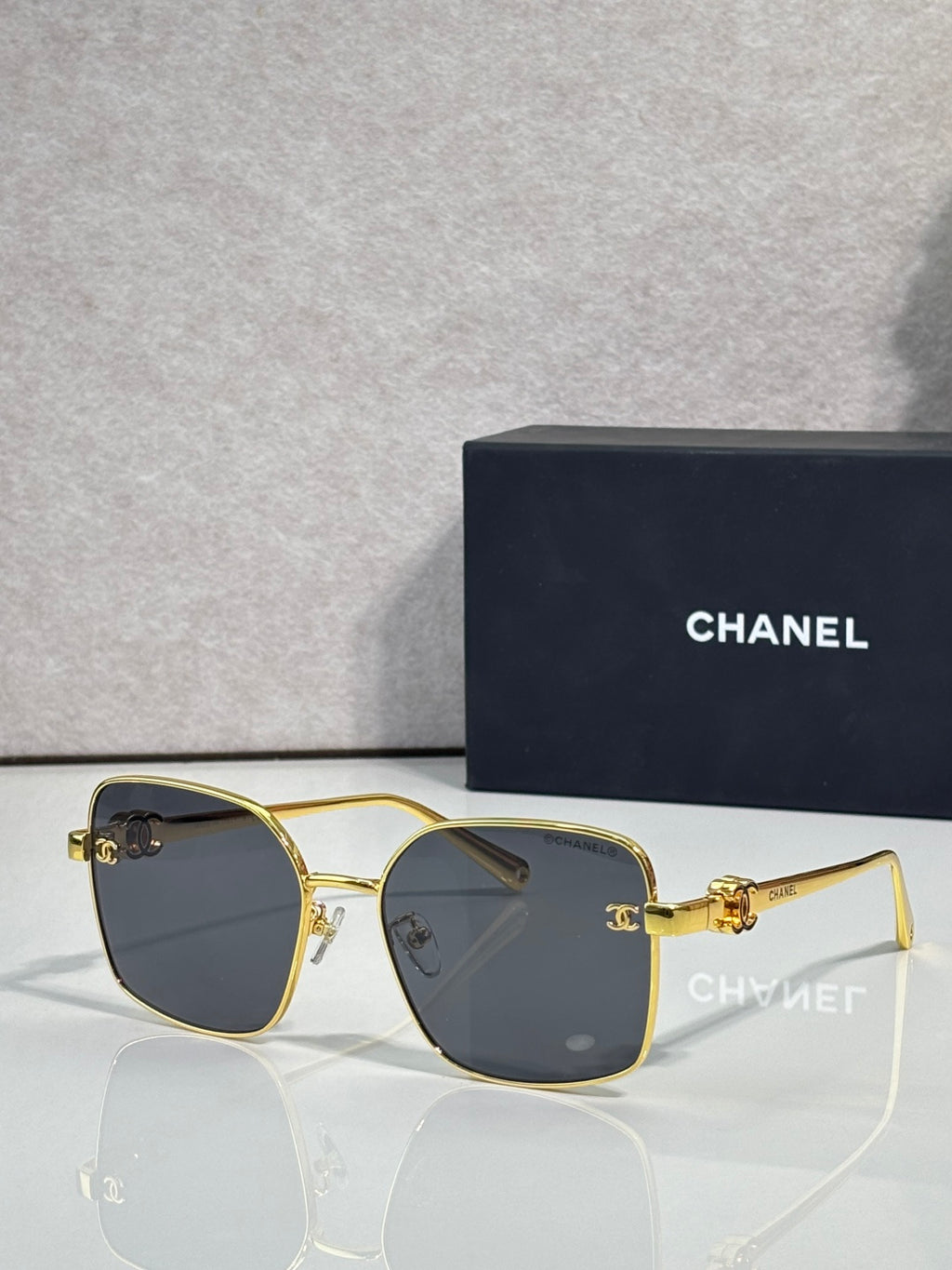 Gold-tone eyeglasses with dark gray lenses and slim metal frame