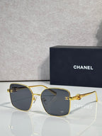 Gold-tone eyeglasses with dark gray lenses and slim metal frame