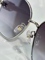 Chanel sunglasses close-up with silver frame and dark lenses