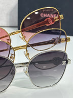 Chanel sunglasses close-up with gold and silver frames and tinted lenses
