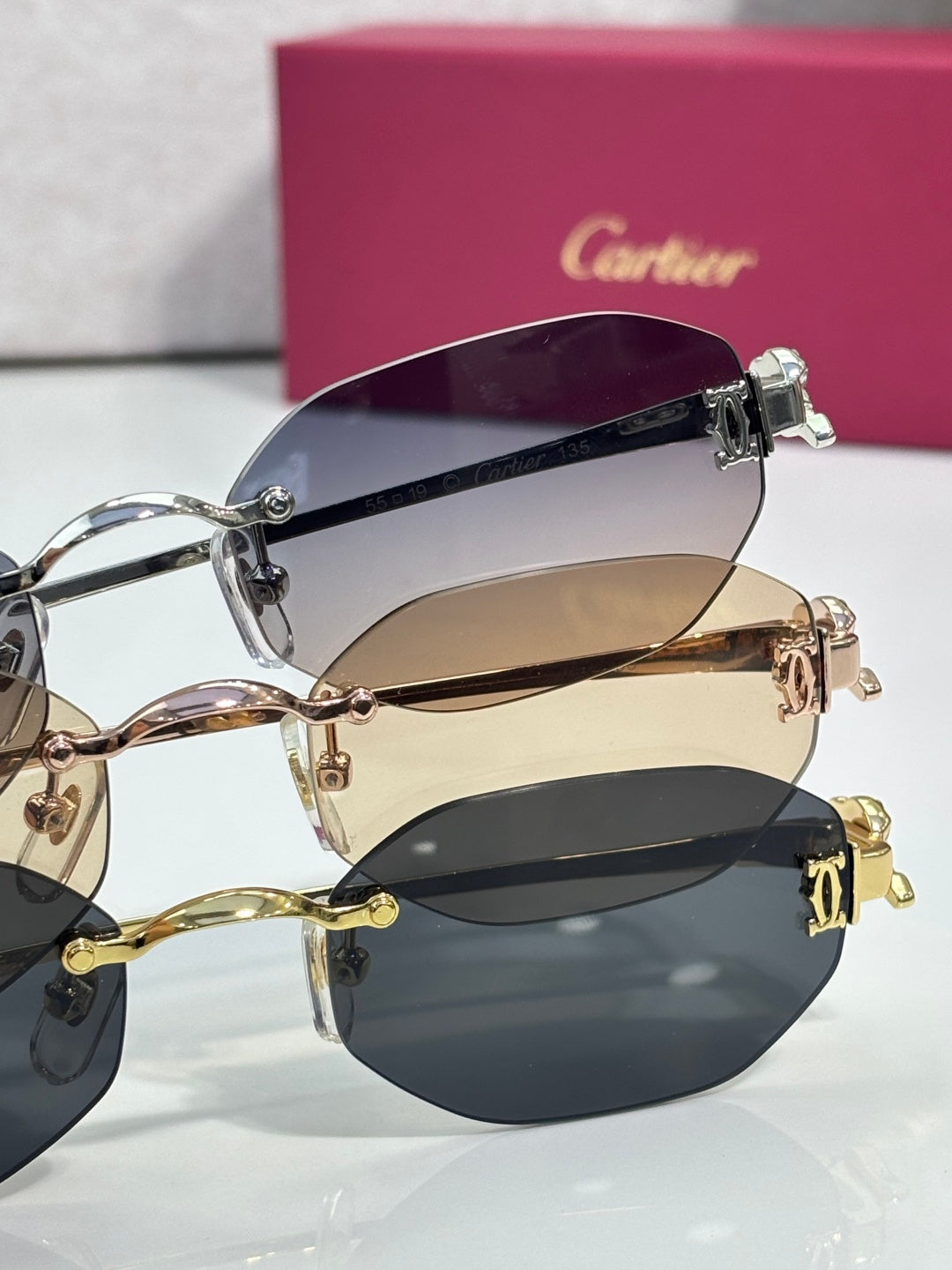 Round sunglasses close-up with dark lenses and gold-tone side hinges
