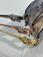 Metal sunglasses frame detail with engraved hinge and matching temple hardware