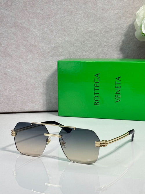 Sunglasses with dark gradient lenses and gold metal frame