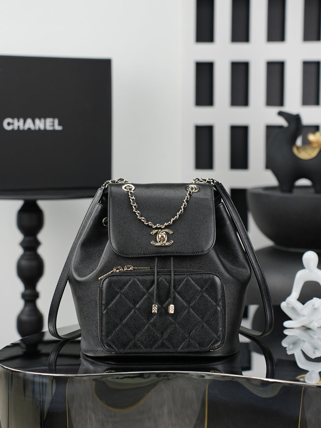 Chanel black mini bag with chain strap, front flap, and quilted pocket front