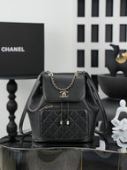 Chanel black mini bag with chain strap, front flap, and quilted pocket front