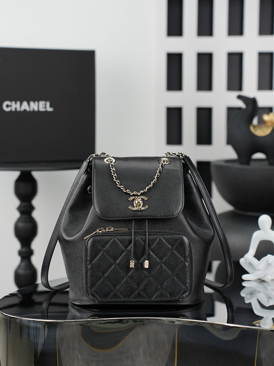 Chanel black mini bag with chain strap, front flap, and quilted pocket front