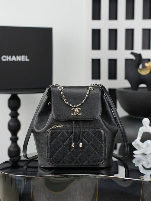 Chanel black mini bag with chain strap, front flap, and quilted pocket front