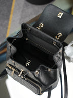 Chanel black small bag with top zip, gold hardware, and open interior