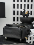 Chanel black structured bag with top zipper, gold hardware, and top handle