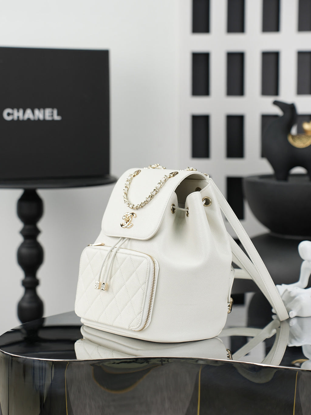 White fabric bucket-style shoulder bag with flap and chain strap