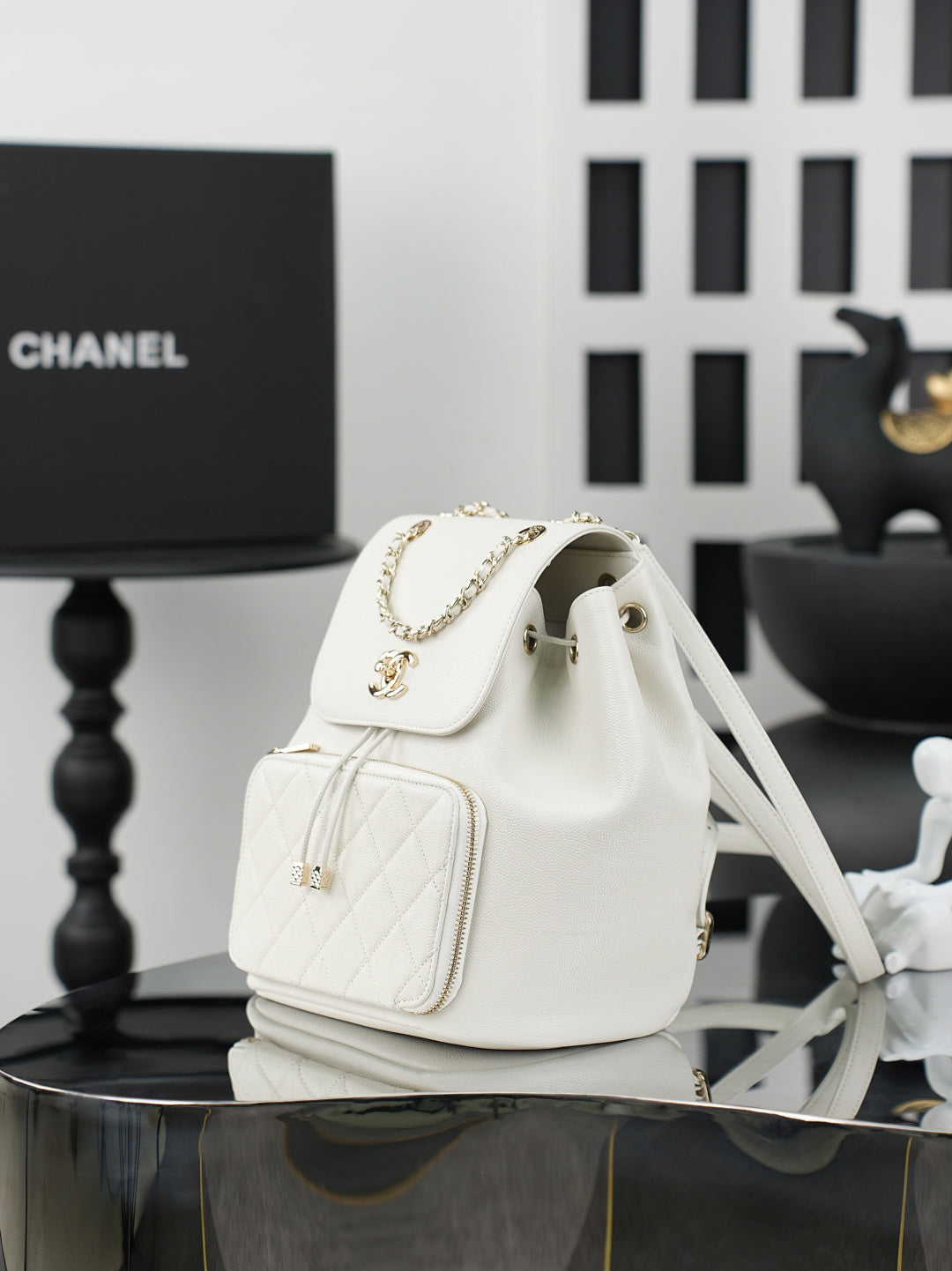 White fabric bucket-style shoulder bag with flap and chain strap