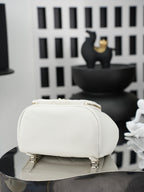 White small top-handle bag with zipper closure and textured front panel