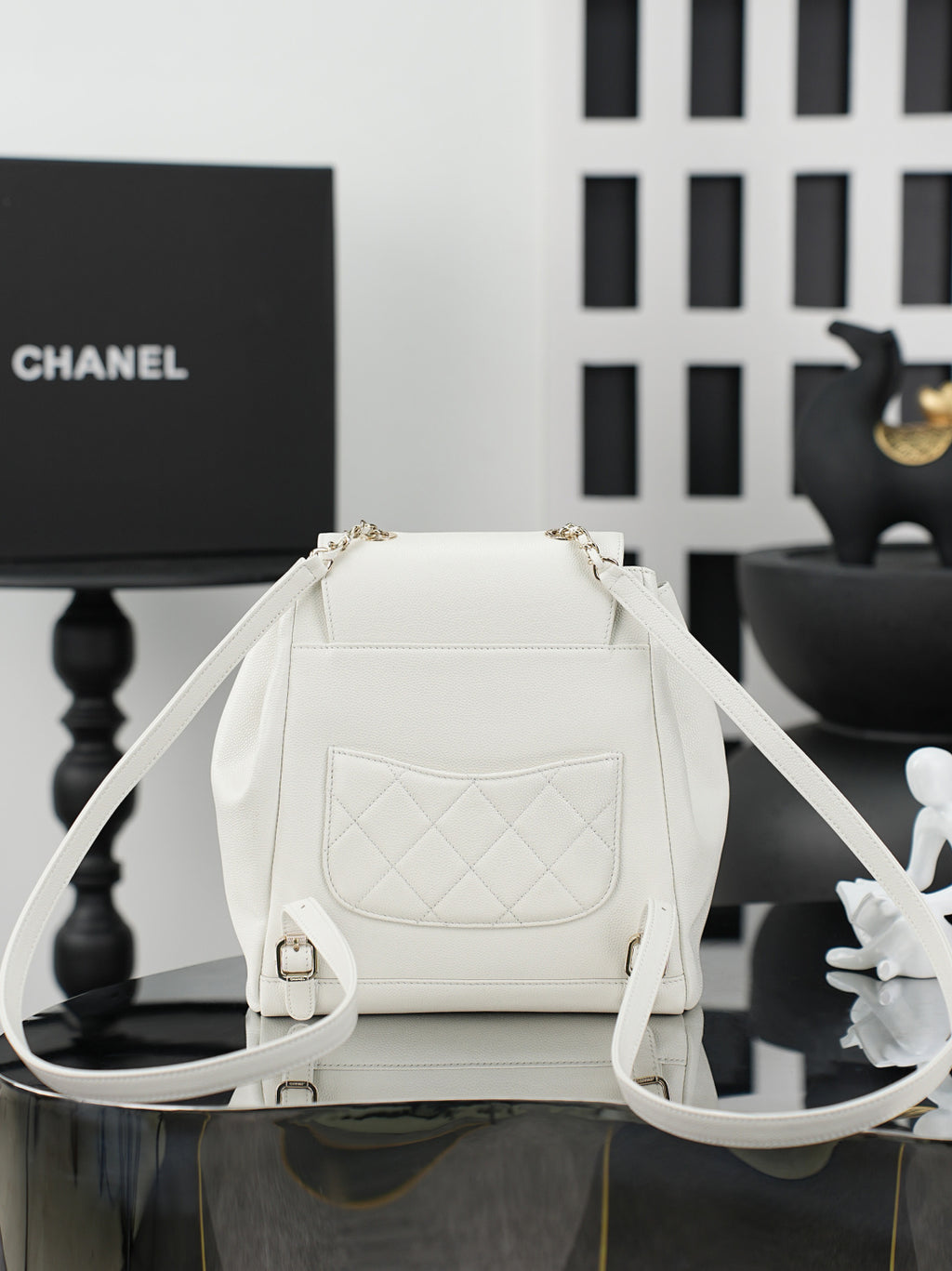White flap shoulder bag with front pocket and adjustable shoulder strap