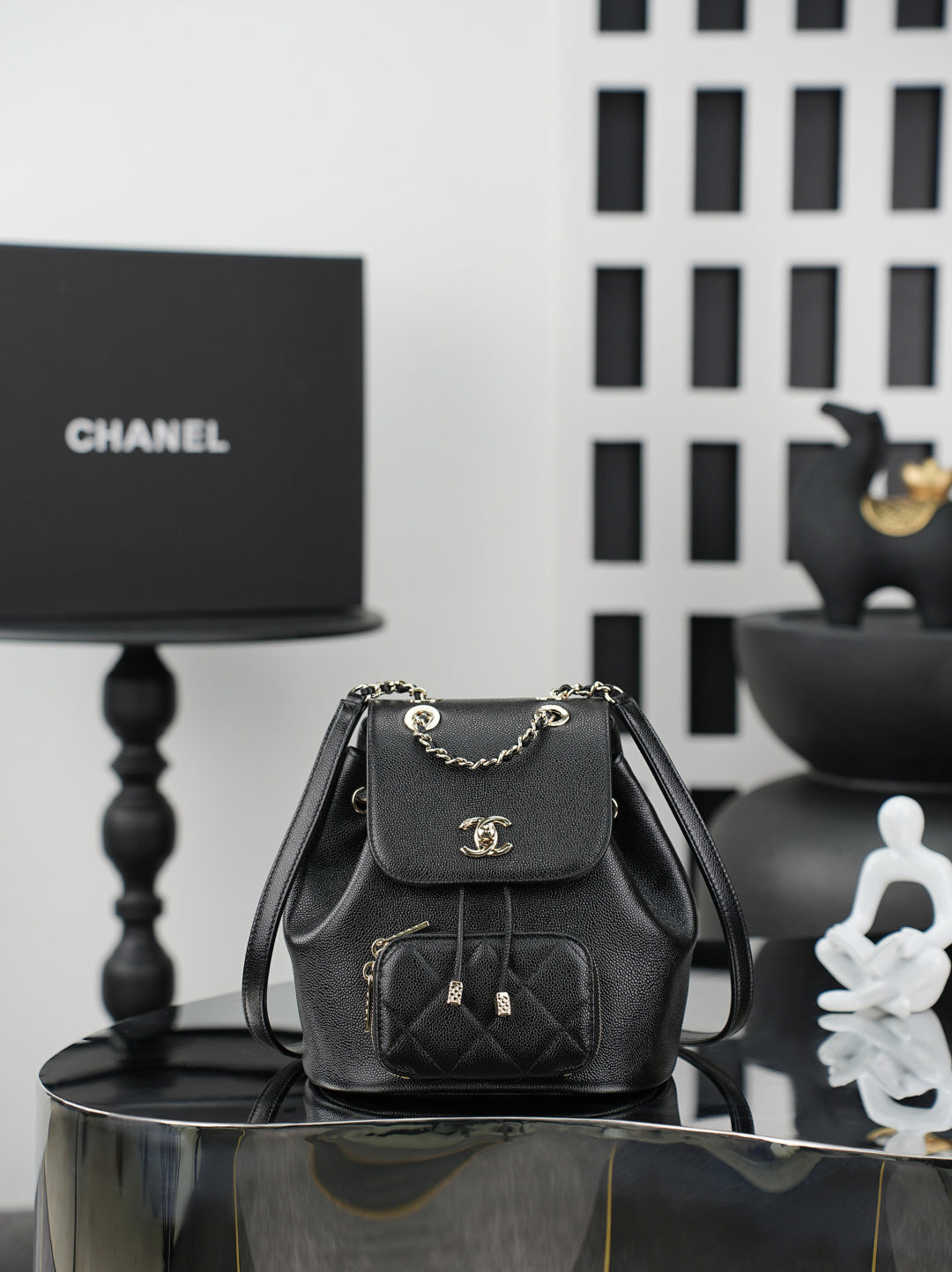Chanel small black bucket bag with chain strap and flap front pocket